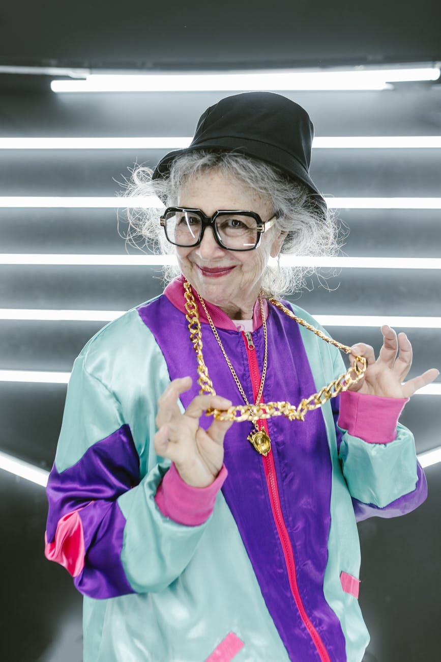 woman in purple jacket with gold necklace